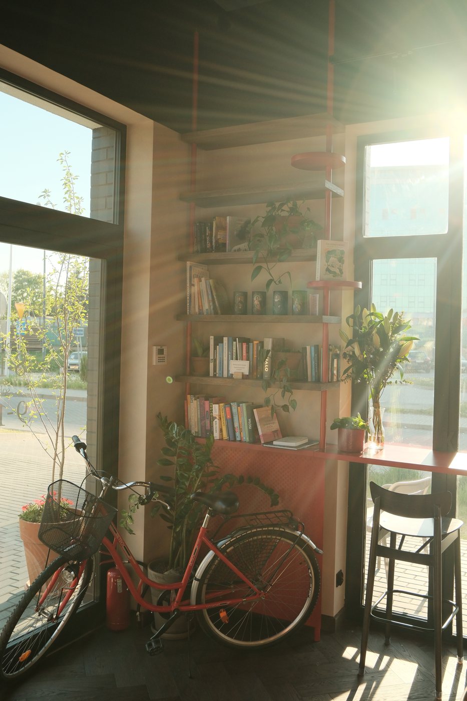 Rower i biblioteczka przy oknie kawiarni